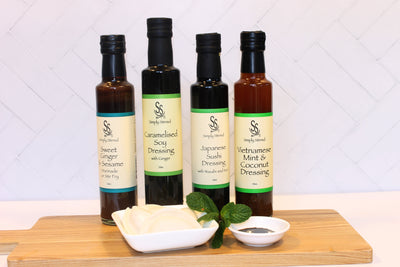 Beautiful image of 4 bottles of Asian influenced dressings Simply Stirred