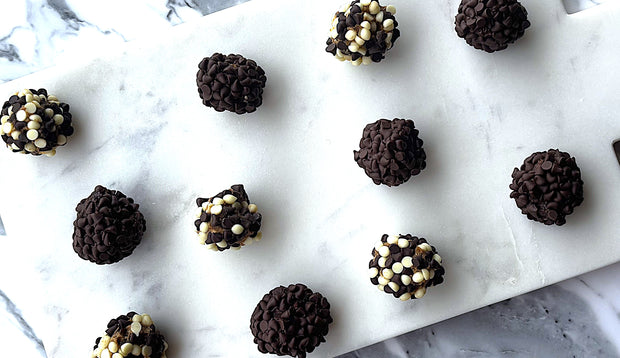 Chocolate and Sticky Date Delite Bites  with white and dark chocolate on a marble surface
