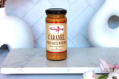 Jar of Pudding Lady caramel fudge sauce with rum on kitchen bench