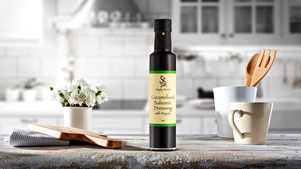 Bottle of Caramelised Balsamic Dressing with Pepper displayed on beautiful kitchen bench 