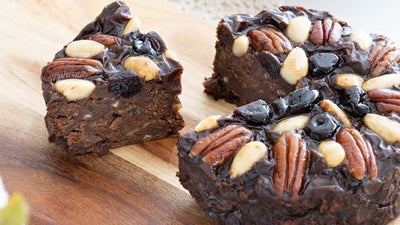 Pudding Lady Chocolate Fruitcake with a piece served on wooden board