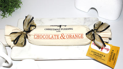 Christmas pudding with chocolate and orange flavor decorated with calico and ribbon 