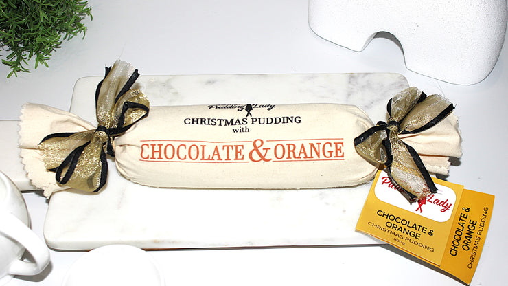 Christmas pudding with chocolate and orange flavor decorated with calico and ribbon 