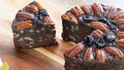 Pudding Lady Chocolate and Pecan cake sliced on wooden board