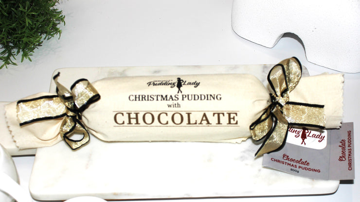 Christmas pudding with chocolate wrapped in calico with a gold bow, branded 'Pudding Lady'.