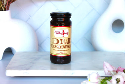 Jar of Pudding Lady chocolate fudge sauce with rum on kitchen bench