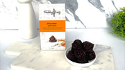 Chocolate Delite Bites with 'Pudding Lady' packaging on a marble surface.