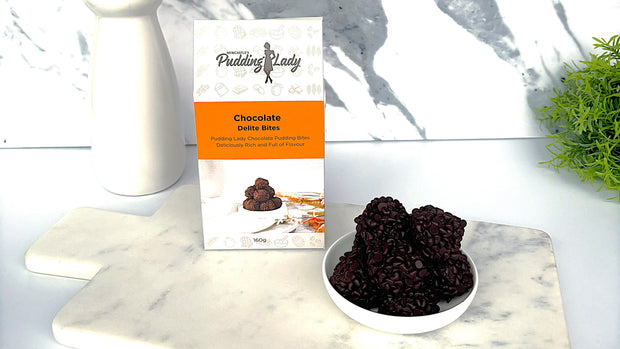 Chocolate Delite Bites with 'Pudding Lady' packaging on a marble surface.
