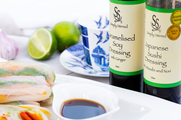 simply stirred dressing bottles displayed with rice paper rolls plated beautifully