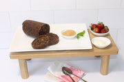 Log pudding displayed sliced with custard and fruit on the side