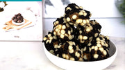 Sticky Date delite bites in white bowl with packaging blurred in background