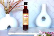 bottle of toffee apple liqueur by Pudding Lady sitting on a white bench 