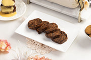 Chocolate and Orange pudding log sliced on white plate on beautiful table setting 