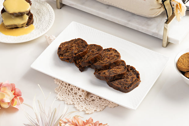 Chocolate and Orange pudding log sliced on white plate on beautiful table setting 