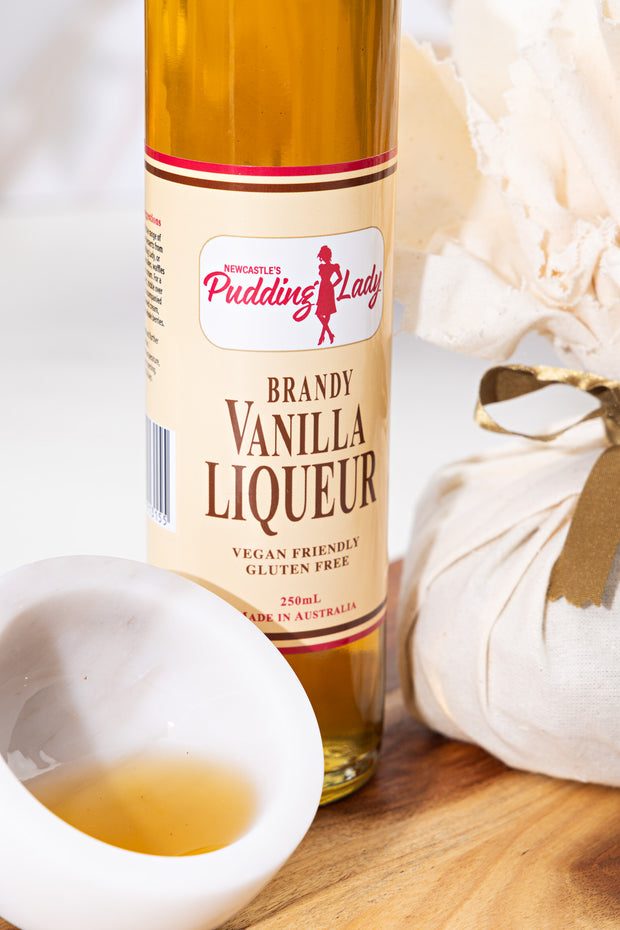 Bottle of vanilla liqueur on a wooden board with 