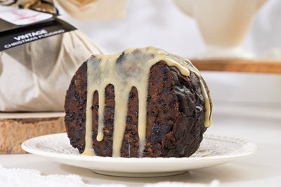 Whole vintage christmas pudding with custard pour