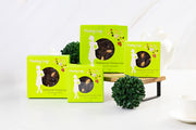 Green boxes of pudding lady Christmas cake on a white background