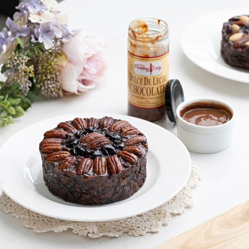 Pudding Lady Chocolate and Pecan cake plated with chocolate sauce on side